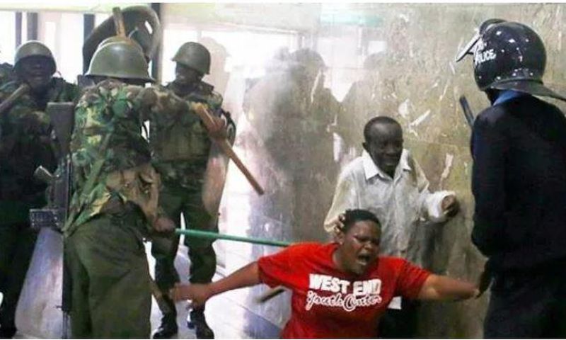 Police whipping Kenyans who were caught up in the night of terror