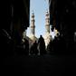 People shop on roofed Khayamiya Street in the old city of the Egyptian capital Cairo; A young Egyptian filmmaker imprisoned for directing a music video critical of President Abdel Fattah al-Sisi has died in a Cairo jail