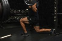 Mid adult man, lifting weights, low section