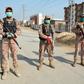 Soldiers guard a road leading to the Taftan quarantine facility