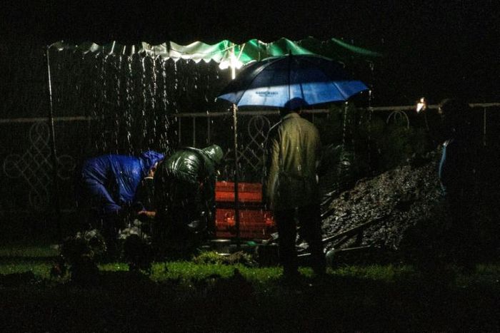Gravediggers conduct an "express burial" at night in Managua, Nicaragua, a procedure that has become more common since the beginning of the COVID-19 pandemic