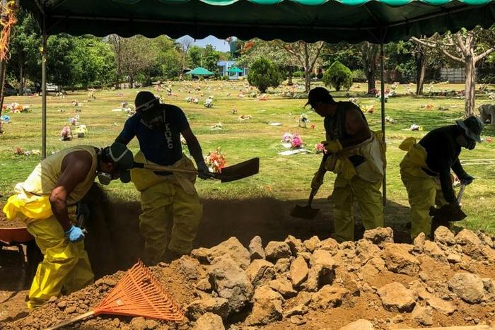 Men dig a grave at a cemetery in the Nicaraguan capital Managua