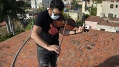 Cuban violinist William Roblejo rehearses on the rooftop of his house in Havana