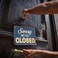 An employee of Havana's El Cafe coffee shop puts up a sign that has become a familiar sight during the coronavirus pandemic