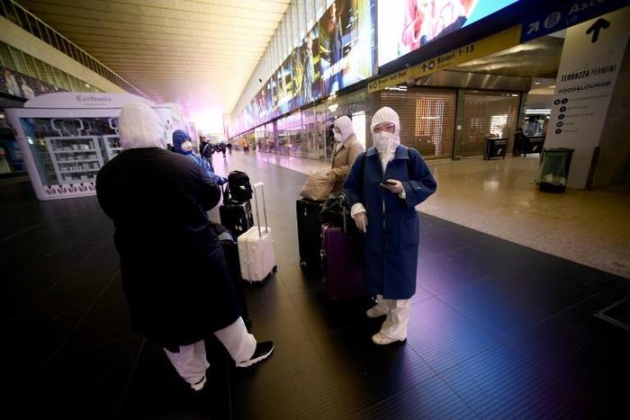 A group of asian travellers arrive in Termini central station in Rome, during Italy's lockdown