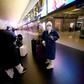 A group of asian travellers arrive in Termini central station in Rome, during Italy's lockdown