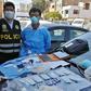 A Peruvian police photo showing Chinese citizen Zhang Tianxing (R) after his arrest for the unauthorized use of stolen COVID-19 tests in a street in Lima, on April 12, 2020