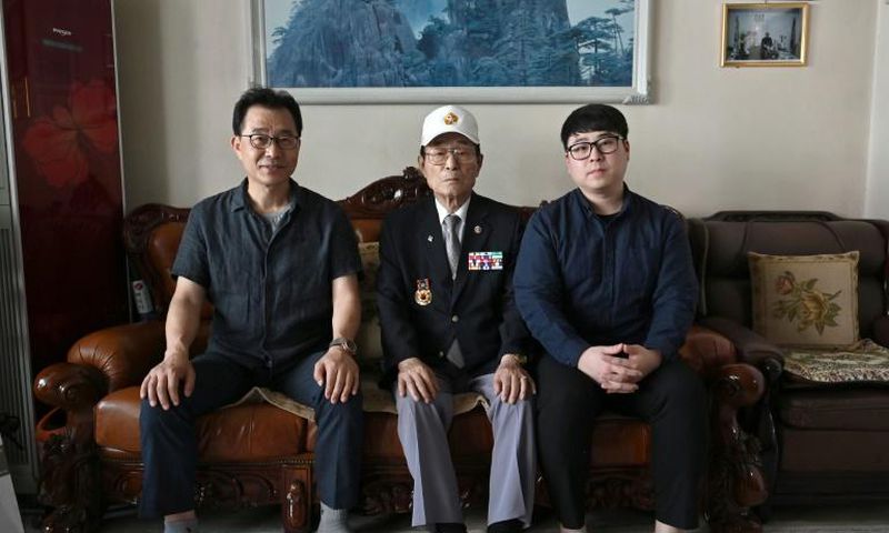 Yang Tae-sung (centre) with his son Yang Kyung-mo (left) and grandson Yang Hee-kon (right) at his home in Seoul