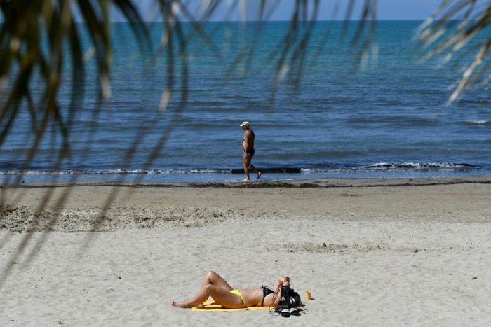 People sunbathe in Durres as Albania reopen beaches after weeks of lockdown