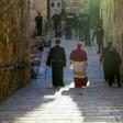 Archbishop Pierbattista Pizzaballa (C), Apostolic Administrator of the Latin Patriarchate of Jerusalem, makes his way through a largely empty Holy City to the Church of the Holy Sepulchre for the Easter Sunday service