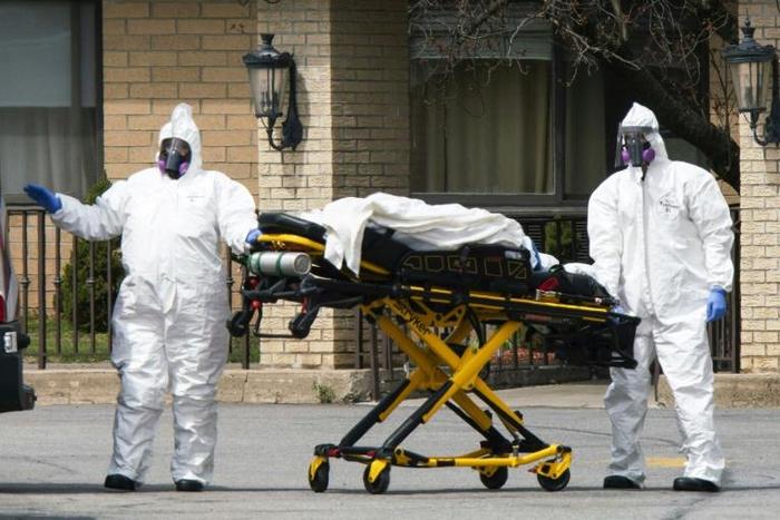 Medical personnel transport a body at the Andover Subacute and Rehabilitation Center in New Jersey on April 16, 2020