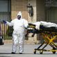 Medical personnel transport a body at the Andover Subacute and Rehabilitation Center in New Jersey on April 16, 2020