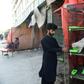 A pet shop owner feeds an animal outside his shuttered store in Karachi