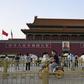People cycle past Tiananmen gate on the eve of the 31st anniversary of the June 4, 1989 crackdown on pro-democracy protests in Beijing