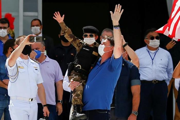 Brazil's President Jair Bolsonaro, pictured (center, in blue) on May 17 2020, shares his US counterpart's tendency to disregard scientific evidence that contradicts him
