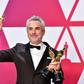 Alfonso Cuaron poses with his Oscars at the Academy Awards on February 24, 2019