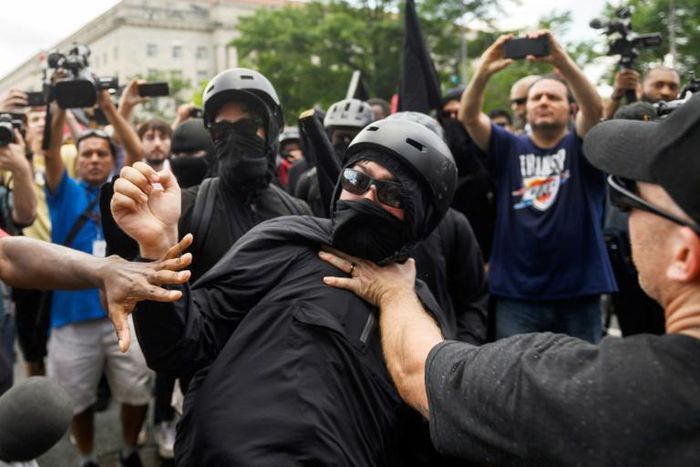 A member of the Antifa group is held back while he argues with a Trump supporter during a rally of right-wing groups in Washington on July 6, 2019.