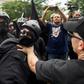 A member of the Antifa group is held back while he argues with a Trump supporter during a rally of right-wing groups in Washington on July 6, 2019.
