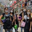Shop sellers wear masks in the Brazilian city of Sao Paulo, where a state of emergency has been declared over the coronavirus pandemic