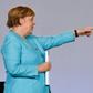 German Chancellor Angela Merkel points to Finance Minister Olaf Scholz after announcing the new stimulus package
