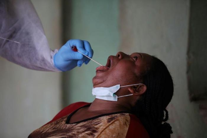 Open wide: A health worker takes a swab during a coronavirus test campaign in the Nigerian capital Abuja