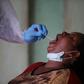Open wide: A health worker takes a swab during a coronavirus test campaign in the Nigerian capital Abuja