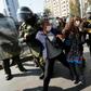 Riot police arrest demostrators in Santiago on Friday after breaking up a May Day protest that contravened social distancing rules