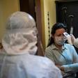 A health officer checks the temperature of an Istanbul resident. Nearly 6,000 teams of "tracers" track potential cases of the novel coronavirus 24 hours a day