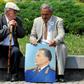 Two admirers reminisce about the late Yugoslav communist president Josip Broz Tito, commemorated in the portrait