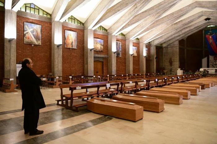 At one point, dozens of coffins were laid out in the church as the death toll in the region soared