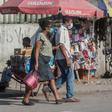Two people in the Haitian capital Port-au-Prince wear face masks while shopping; a first coronavirus victim has died in Haiti, the government said on April 5, 2020
