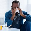 man sneeze sick cold tissue blow nose