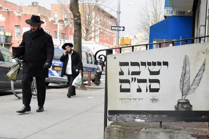 (FILES) In this file photo Orthodox Jewish men walk in the Brooklyn neighborhood of Crown Heights on February 27, 2019 in New York. The United States saw a record number of anti-Semitic incidents last year, including a sharp spike in physical attacks, ...