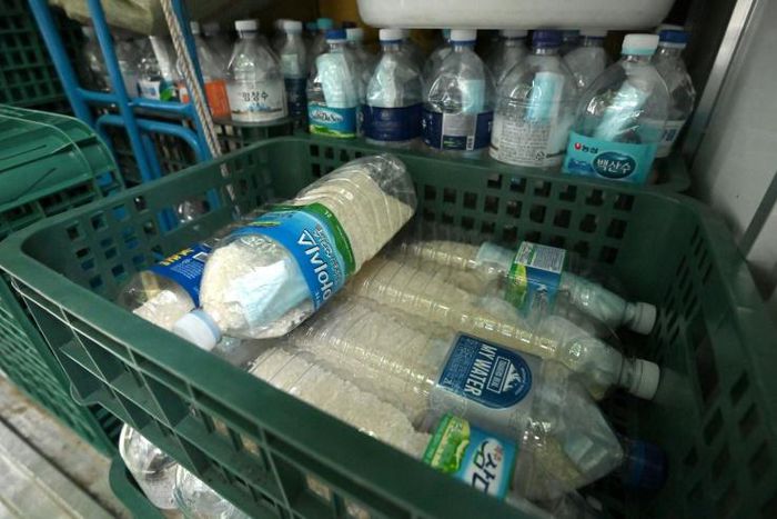 North Korea has been conducting a series of staged provocations aimed at forcing concessions from Seoul and Washington; pictured June 18, 2020 in Seoul are plastic bottles filled with rice and face masks, loaded on a truck of NKorean defector Park Jung...