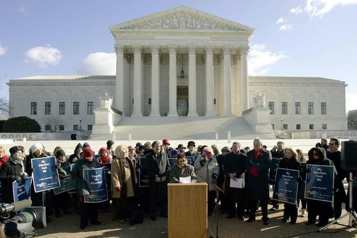 Norma McCorvey (C-Podium), the Roe of Roe v. Wade, speaks on the steps of the US Supreme Court on January 18, 2005 after petitioning the court to reverse its landmark decision that granted women the right to an abortion