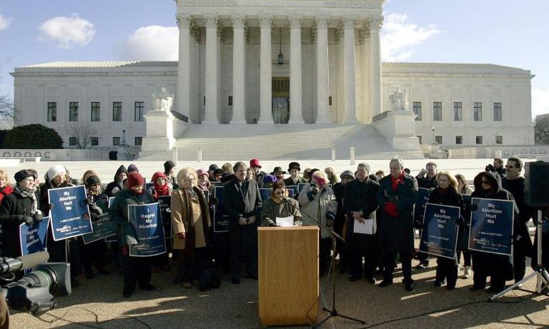 Norma McCorvey (C-Podium), the Roe of Roe v. Wade, speaks on the steps of the US Supreme Court on January 18, 2005 after petitioning the court to reverse its landmark decision that granted women the right to an abortion