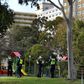 Police stand guard outside a public housing estate locked down in Melbourne due to a spike in coronavirus cases
