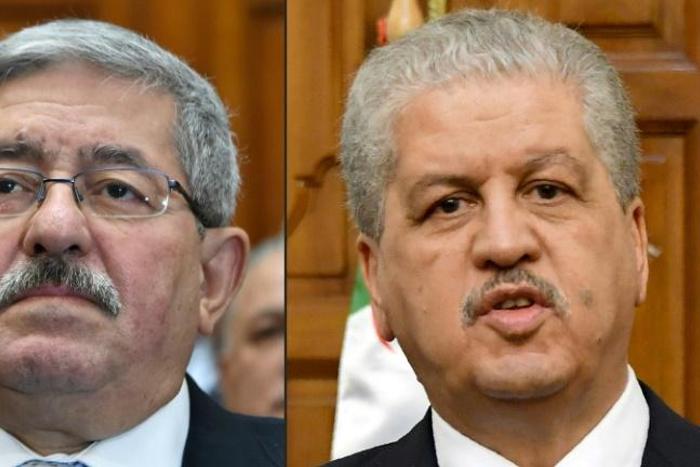 This combination of pictures created on December 10, 2019 shows file photos of then newly appointed Algerian prime minister Ahmed Ouyahia attending a congress session in the capital Algiers on September 4, 2017 and Algerian Prime Minister Abdelmalek Se...