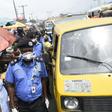 Lagos Police Commissioner Hakeem Odumosu squeezes his way through a market to monitor compliance with  measures to curb the spread of coronavirus