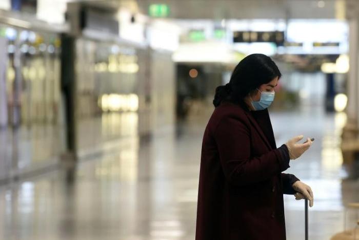 Wearing a mask and gloves in a terminal of Franz-Josef-Strauss Airport in Munich