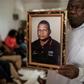 A spokesperson for bereaved relatives holds a portrait of Anastacio Matavele, an election monitor who was gunned down ahead of a key vote last October