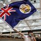 A protester waves the former British colonial Hong Kong flag at arally in a shopping mall. A new Chinese security law imposed on the city is causing fresh tension between London and Beijing