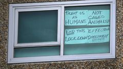 A sign is seen pasted on a window at one of nine public housing estates locked down due to a spike in COVID-19 coronavirus numbers in Melbourne