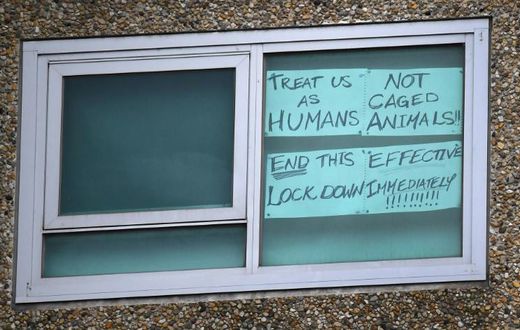 A sign is seen pasted on a window at one of nine public housing estates locked down due to a spike in COVID-19 coronavirus numbers in Melbourne