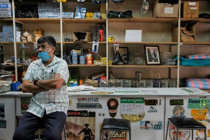 In a store that sells bicycle spare parts, the Shah brothers are feeling the impact of the pandemic on the economy