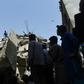 Rescuers search for victims in the rubble of a collapsed residential building in the Pakistani city of Karachi on Thursday