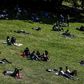 People enjoy the sun in a Paris park, but experts fear a surge in coronavirus infections
