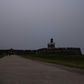 A woman rides her bike in front of El Morro Fort as a vast cloud of Sahara dust blankets the city of San Juan, Puerto Rico on June 22, 2020