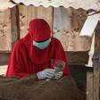 A woman in Djibouti selling khat leaves, a mild stimulant, wears a mask and gloves to ward off the COVID-19 illness