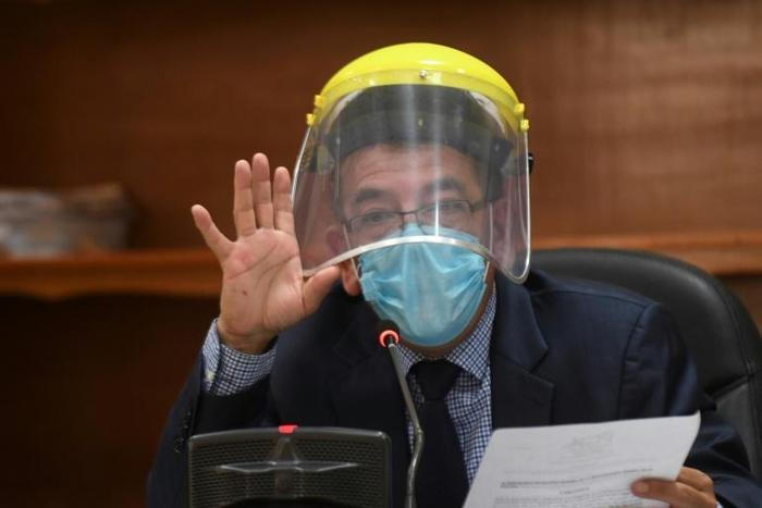 Judge Miguel Angel Galvez wears a face shield and a mask during a hearing against Guatemalan ex-president Otto Perez in Guatemala City on May 12, 2020